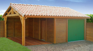 garage en béton aspect bois 2 pentes couverture tuiles entrée en façade avec un portail basculant et un auvent accolé en pignon