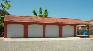 garage en béton 2 pentes couverture tuiles portes sectionnelles et auvent accolé